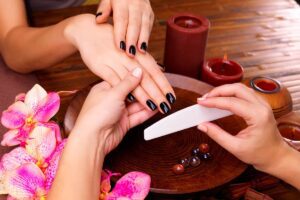 manicurist master makes manicure woman s hands spa treatment concept
